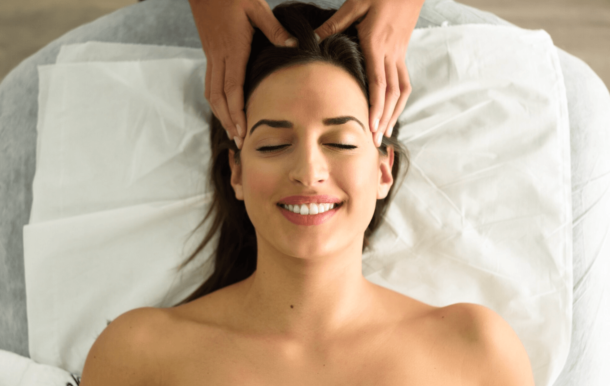 Scalp massage near me in lake jackson performed on a woman's scalp