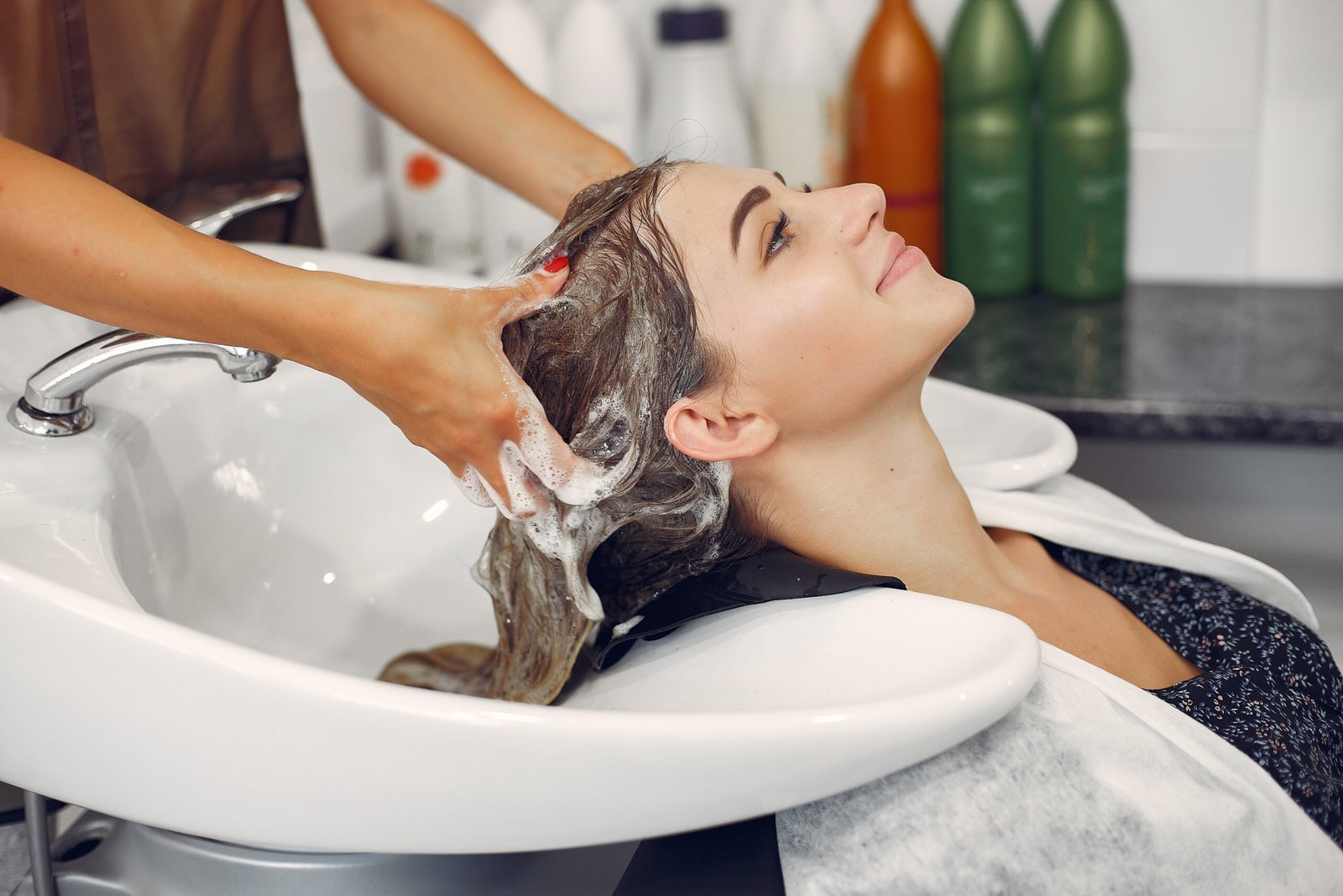 woman getting a shampoo, conditioning and blowdry in lake jackson tx